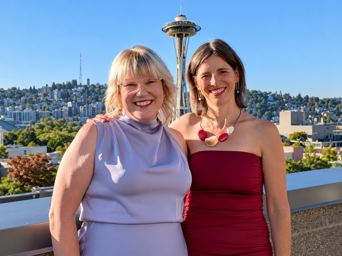 Nina and Miri, the founders of Connected, smiling together with Seattle’s Space Needle behind them.